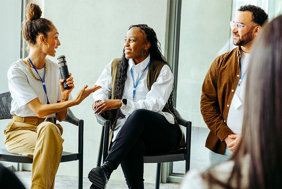 Diverse group of professionals conversing at panel discussion
