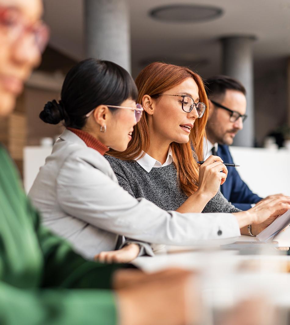 Diverse Team Collaborating During Professional Office Meeting With Documents
