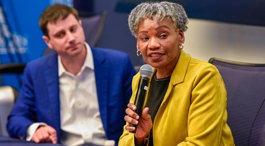 Close up of professional talking at a microphone during a panel discussion
