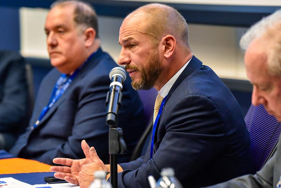 Close up of professional talking at a microphone during a panel discussion