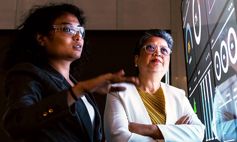 Two professionals reviewing collected data
