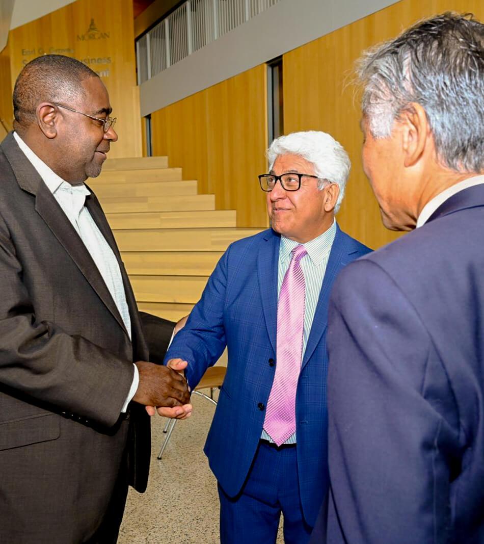 Dr. Ali Emdad, Ph.D. shaking hands with Professionals